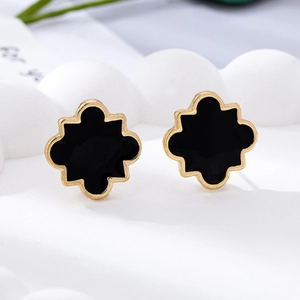 Detail of clover earrings with black enamel and 18K gold plating for a luxury look