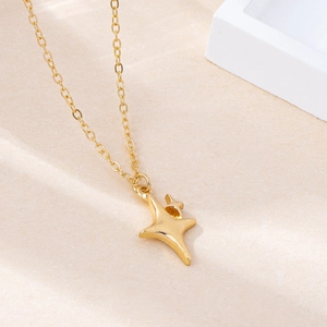 Minimalist gold necklace featuring a polished four-point star pendant on a thin link chain