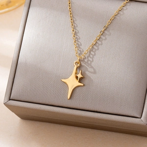 Minimalist gold star pendant necklace displayed on a luxury grey jewelry box gift set
