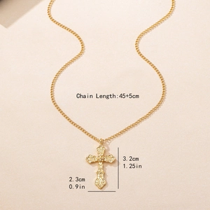 Gothic gold cross pendant necklace with vintage baroque engraving on beige background