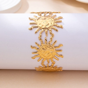 Golden sunburst link bangle with hammered texture displayed on a white cylindrical stand