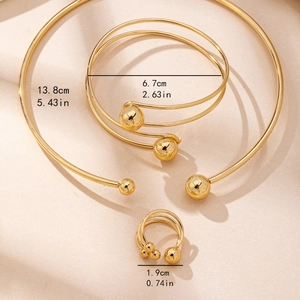 Minimalist gold jewelry set with necklace bracelet and ring featuring ball accents