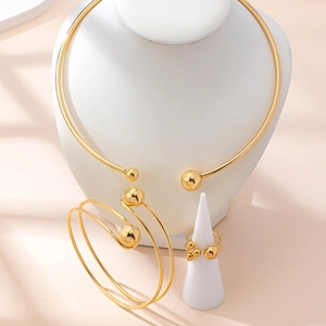 Three-piece gold-tone jewelry set with collar necklace, spiral bracelet and open ring