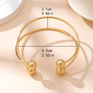 Minimalist double-layered gold cuff bracelet with round beads and open design details