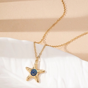 Starfish pendant necklace with blue spiral enamel and gold textured finish