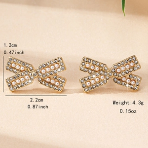 Boucles d'oreilles nœud dorées avec strass brillants et perles blanches pour femme