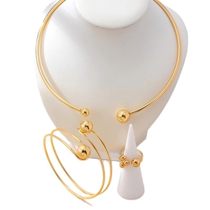 Minimalist gold jewelry set including open choker, spiral bangle and ball ring for women
