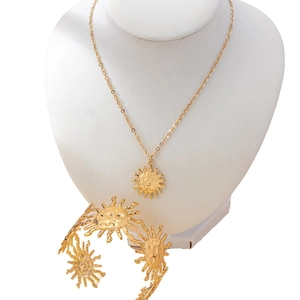 Golden sun jewelry set featuring hammered texture necklace and open cuff bracelet