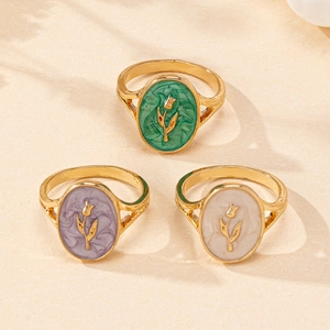 Detail view of retro tulip rings with marble texture enamel in green, purple, and cream