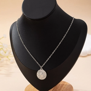 Elegant vintage silver sun face pendant necklace displayed on a black neck mannequin