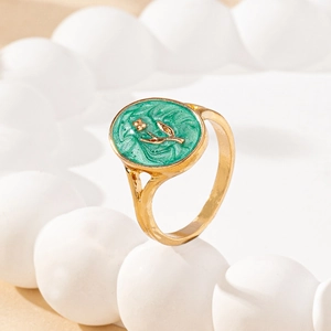 French vintage style gold ring with oval green enamel tulip motif on white ceramic stand