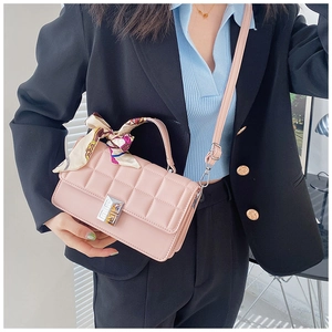 Pink quilted square crossbody bag with silver buckle and decorative scarf on model