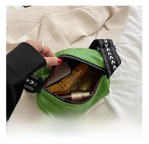 Detail view of green quilted PU leather bag interior showing capacity and wide strap