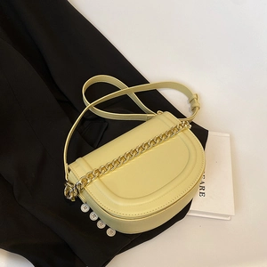 Chic cream yellow saddle bag with gold chunky chain and slim leather shoulder strap