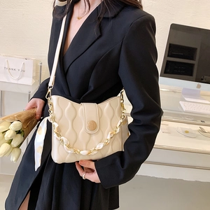 Creamy white wave-quilted shoulder bag with floral scarf chain and wood-texture button