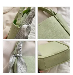 Detail showing light green lychee texture leather handbag with floral silk scarf decor