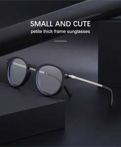 Close-up of black round sunglasses with silver metal temples on geometric steps