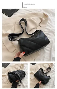 Detail of black diamond-quilted PU leather bag with geometric wide strap and rectangle shape