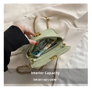 Internal capacity of green quilted chain bag showing space for phone and perfume
