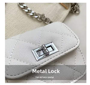 Close-up of white quilted leather mini bag featuring a silver metal twist lock closure