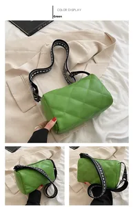 Detailed view of a green quilted PU leather crossbody bag with a woven wide shoulder strap