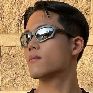 Futuristic cyberpunk wraparound sunglasses with silver mirror lenses on model