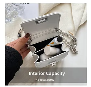 Internal capacity of white quilted crossbody bag with metal chain and cosmetics