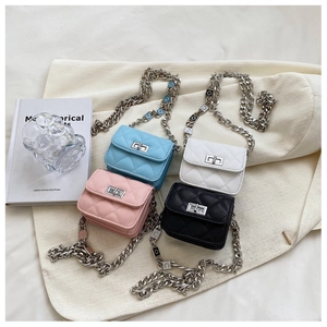 Close-up of mini quilted chain bags in blue, white, pink and black with metal clasps