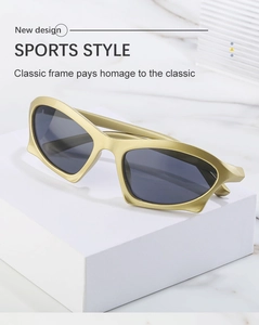 Detail of vintage Y2K sports sunglasses with gold matte frame and dark lenses on marble