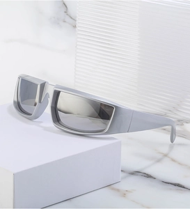 Detail of matte silver steampunk sunglasses with mirrored lenses on a modern stand
