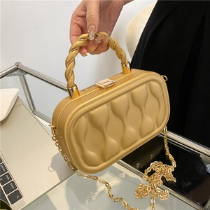Elegant gold hard-shell evening clutch bag with wavy texture and chain strap