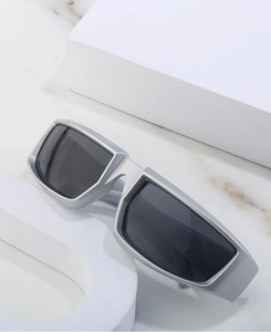 Close-up of futuristic silver wide frame sunglasses with dark grey rectangular lenses