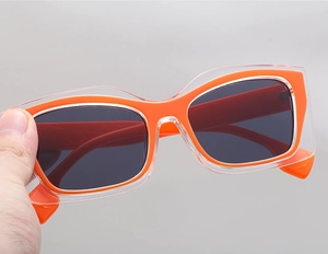 Close-up of orange dual-layer cat-eye frames with dark square UV lenses