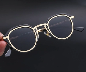 Detailed view of vintage round eyewear frames with black and gold metal fusion design