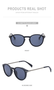 Detail view of matte black retro cat-eye sunglasses with silver metal temples