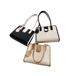 Three pleated contrast color tote bags in black, white and brown for summer commute