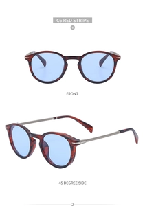 Detail view of red stripe cat eye sunglasses with light blue lenses and metal temples