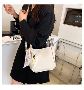 Minimalist beige pebble leather tote bag featuring a decorative printed pink silk scarf
