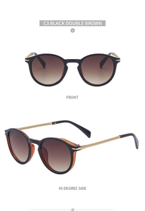 Close-up of retro round sunglasses with black frame, gold metal arms and brown lenses