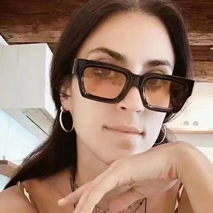 Steampunk rectangular sunglasses with thick black frames and orange tinted lenses