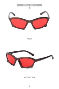 Detail view of punk Y2K sunglasses with dark brown frame and sharp red angular lenses