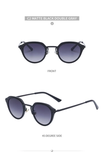 Detail view of matte black small frame cat-eye sunglasses with gradient gray lenses