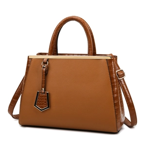 Caramel brown large tote bag with crocodile pattern leather straps and golden metal bar