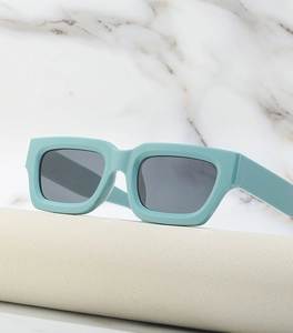 Detailed side view of Y2K steampunk sunglasses with mint green frame and dark grey lenses