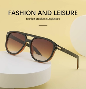 Detail of vintage double-bridge sunglasses featuring gold arrow accents and gradient lenses