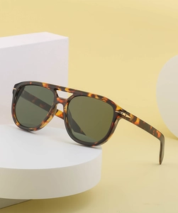 Detail of vintage tortoise shell sunglasses with double bridge and gold metal accents