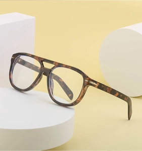 Detail of tortoise pilot sunglasses with double bridge and metal arrow temple accents