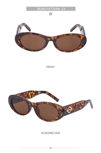 Détails de lunettes de soleil ovales écailles, verres bruns et logo losange doré