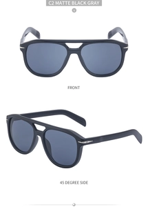 Detail view of matte black double-bridge aviator sunglasses with silver metal arrow accents