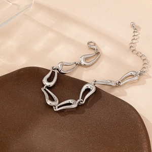 Minimalist silver chain bracelet with organic fluid teardrop links and lobster clasp